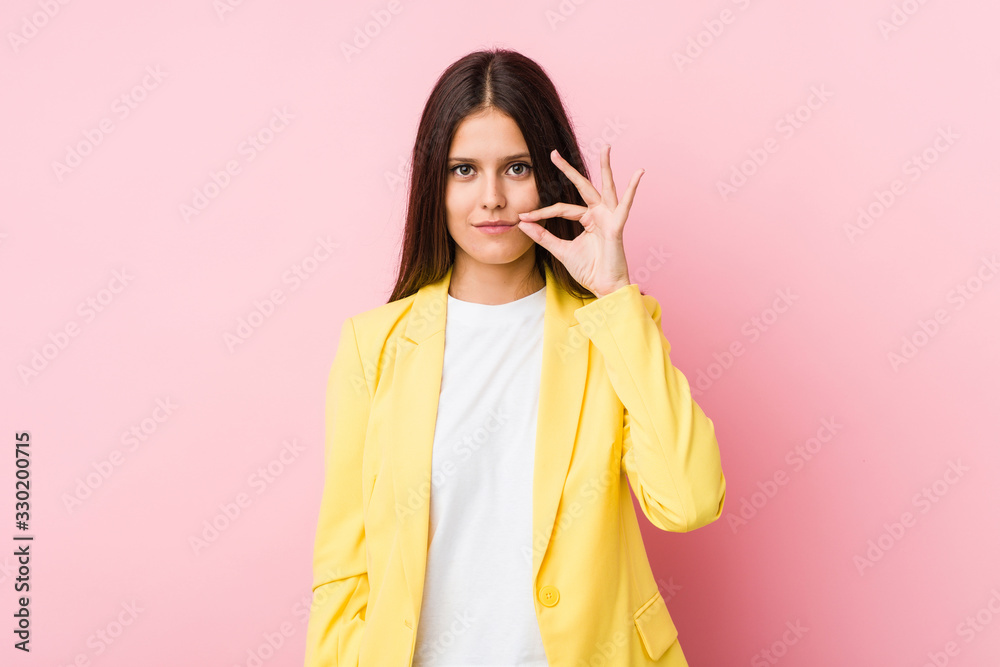Young business woman with fingers on lips keeping a secret. Young business woman with fingers on lips keeping a secret.