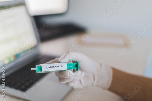Fototapeta Naklejka Na Ścianę i Meble -  Coronavirus COVID-19 SARS virus vaccination cure medicine gloved hand hospital epidemic pandemic laboratory
