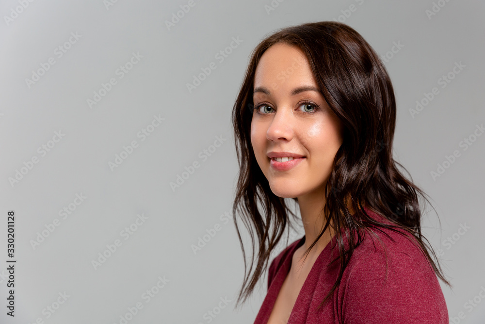 Happy that everything is okay. Portrait of charming friendly caucasian girl smiling cheerfully while standing against gray background, listening order or talking to coworker Happy that everything is okay. Portrait of charming friendly caucasian girl smiling cheerfully while standing against gray background, listening order or talking to coworker