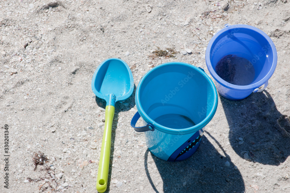 Topview, close distance of a Childs plastic shovel and two blue, Topview, close distance of a Childs plastic shovel and two blue,