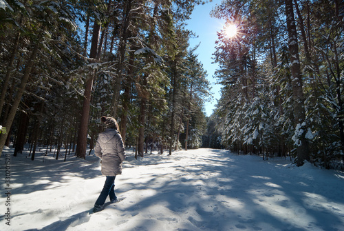woman walking in snow in the forest