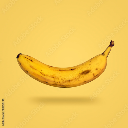 Fotografija flying rip banana isolated on yellow background