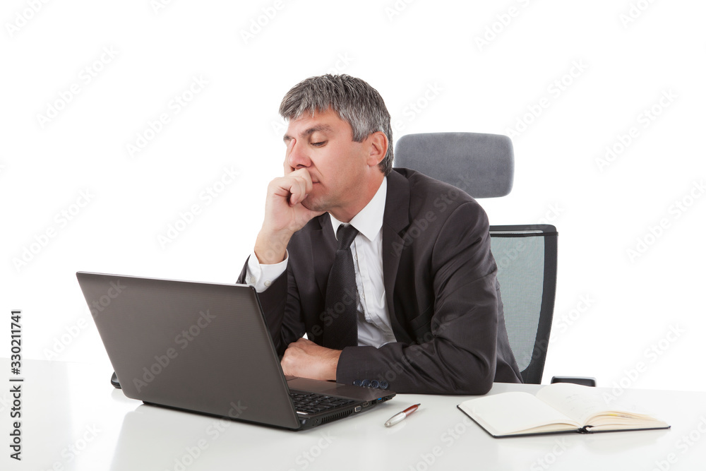 Gray haired casual looking businessman working on laptop computer Gray haired casual looking businessman working on laptop computer