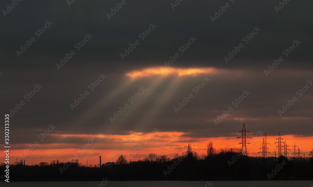 Beautiful cloudy sky with sunbeams at sunset Beautiful cloudy sky with sunbeams at sunset