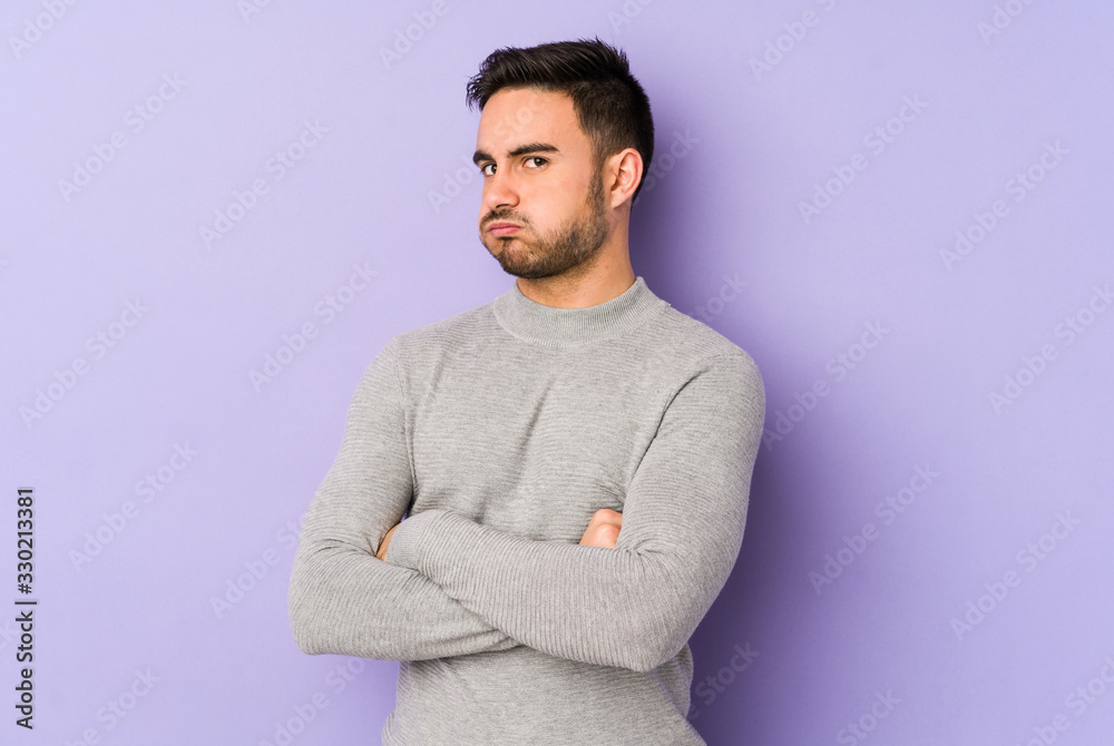 Young caucasian man isolated on purple background tired of a repetitive task. Young caucasian man isolated on purple background tired of a repetitive task.