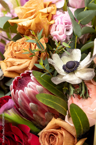 Bright combined bouquet of Protea  roses  anemone coronaria  eucalyptus. Close up.