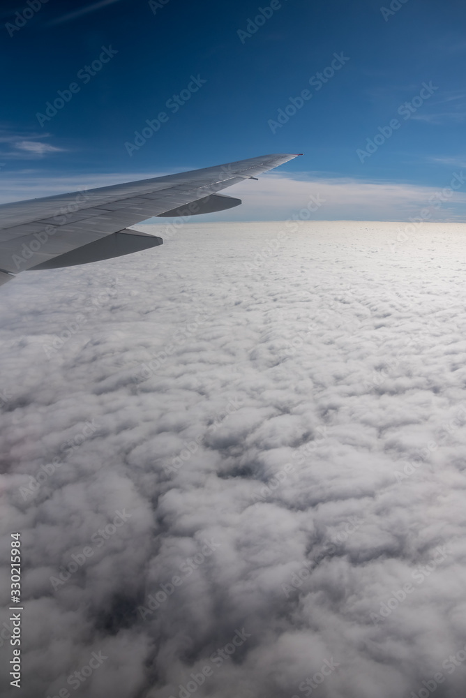 Obraz premium Aerial View from an Airplane. Flying above Clouds at Sunrise