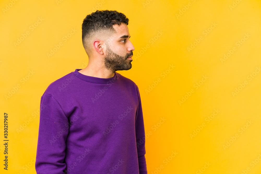 Young mixed race arabic man isolated gazing left, sideways pose. Young mixed race arabic man isolated gazing left, sideways pose.