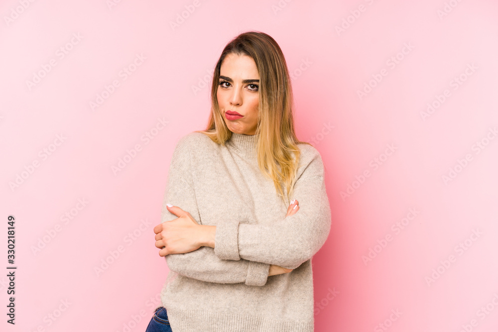 Middle age woman over isolated background frowning face in displeasure, keeps arms folded. Middle age woman over isolated background frowning face in displeasure, keeps arms folded.