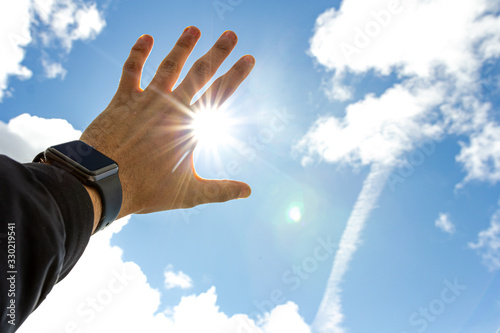 Blocking the bright sun with your hand