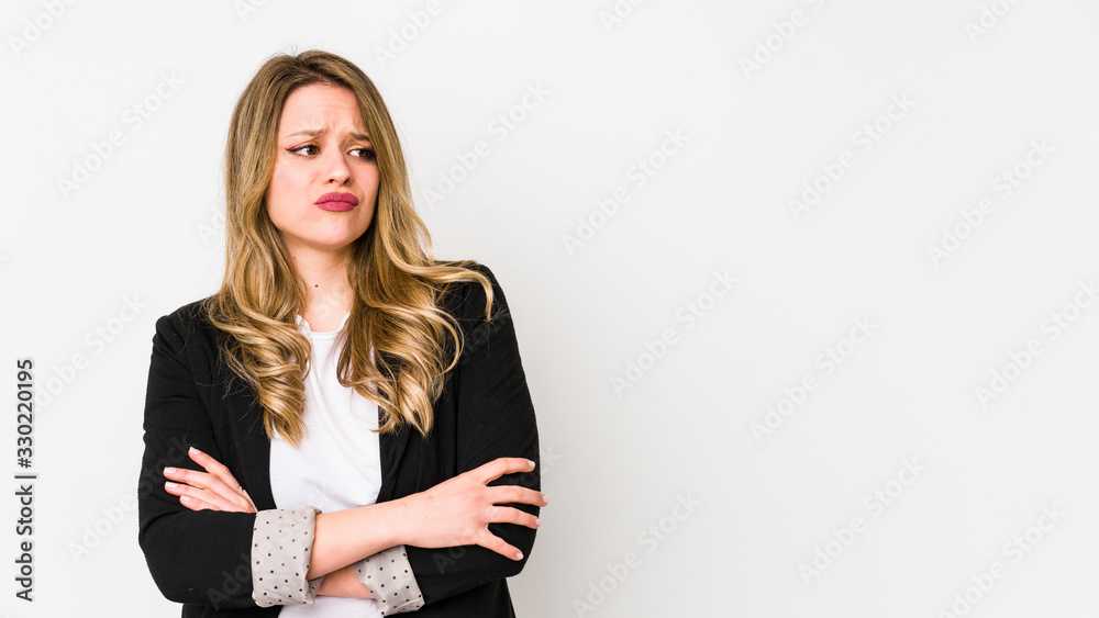 Young caucasian business woman isolated on white background Young caucasian bussines womansuspicious, uncertain, examining you. Young caucasian business woman isolated on white background Young caucasian bussines womansuspicious, uncertain, examining you.