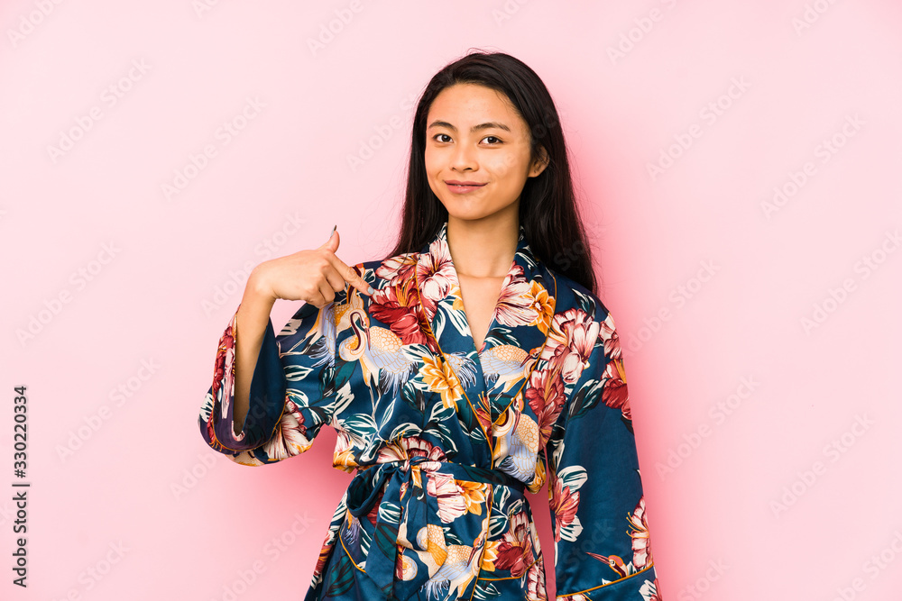 Young chinese woman wearing a asiatic pijama isolated dreaming of achieving goals and purposes Young chinese woman wearing a asiatic pijama isolated dreaming of achieving goals and purposes