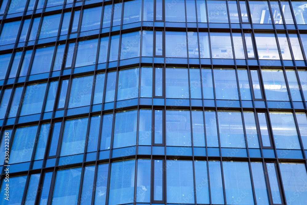 Modern office building facade abstract fragment, shiny windows in steel structure