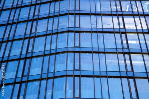 Modern office building facade abstract fragment  shiny windows in steel structure