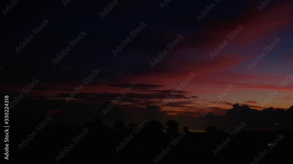 Silhouettes of palm trees on the sunset background. Ubud, Bali, Indonesia. Timelapse. Motion sky. Beautiful amazing view. Rainbow colours. Silhouettes of palm trees on the sunset background. Ubud, Bali, Indonesia. Timelapse. Motion sky. Beautiful amazing view. Rainbow colours.