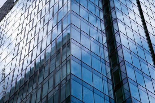 Modern office building facade abstract fragment, shiny windows in steel structure