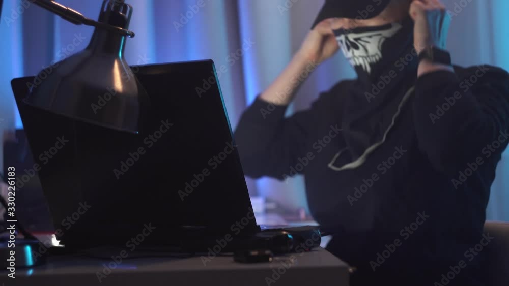 Female hacker sitting at her desk, working. Police siren in window. Woman see it, put on mask, take gun and escape from crime scene. Female hacker sitting at her desk, working. Police siren in window. Woman see it, put on mask, take gun and escape from crime scene.