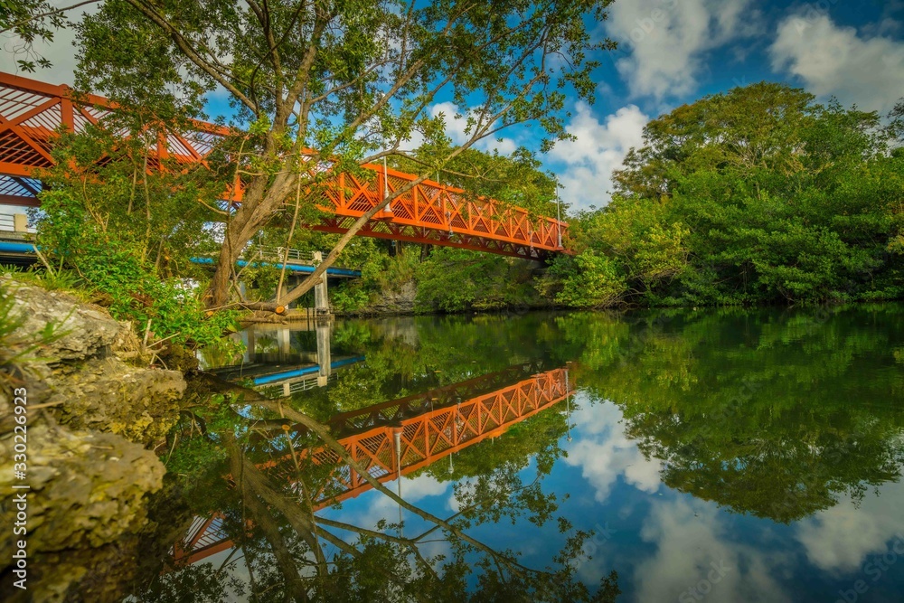 bridge red water lake landscape nature sky forest tree green river calm beautiful florida bridge red water lake landscape nature sky forest tree green river calm beautiful florida