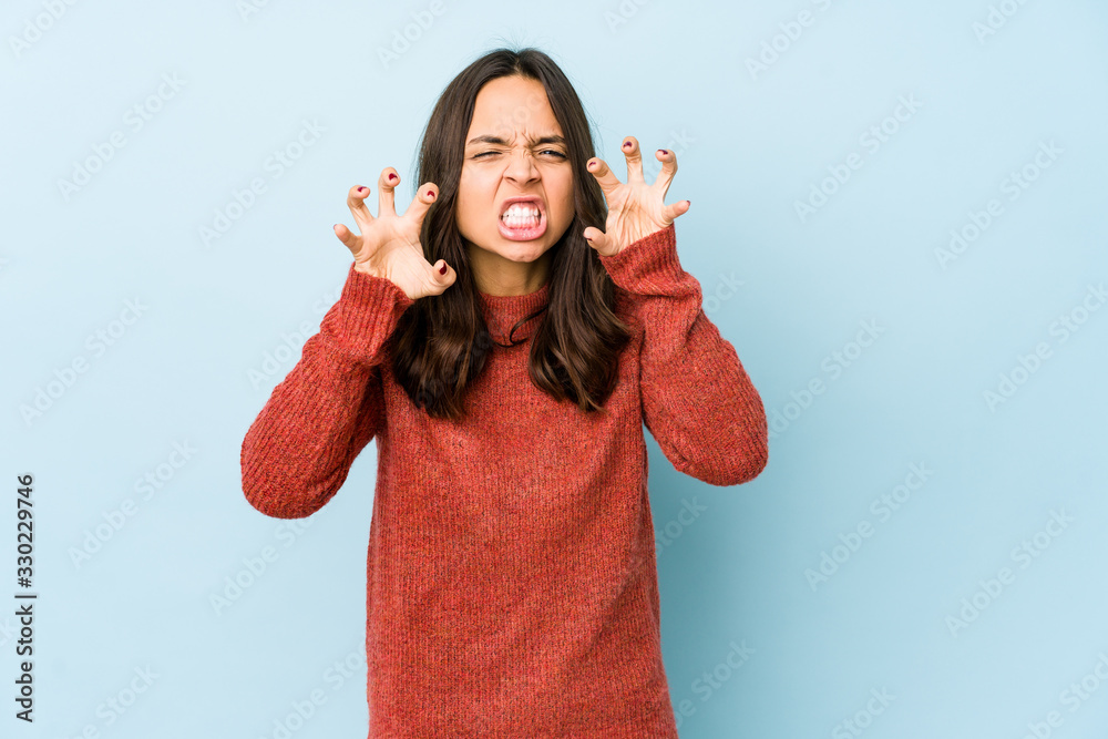 Young mixed race hispanic woman isolated showing claws imitating a cat, aggressive gesture. Young mixed race hispanic woman isolated showing claws imitating a cat, aggressive gesture.