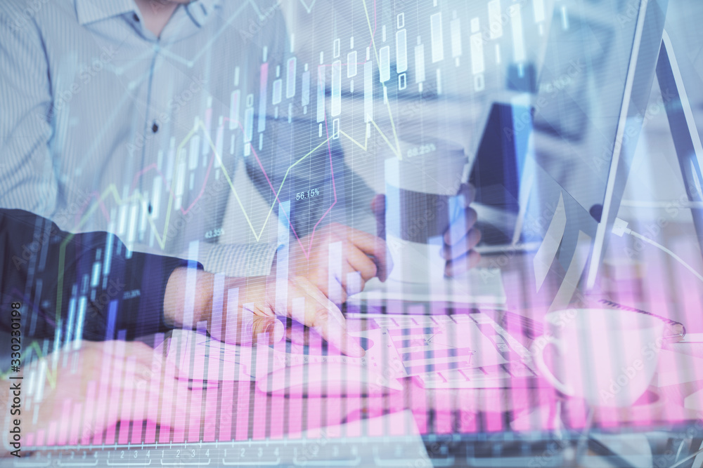 Multi exposure of chart with man typing on computer in office on background. Concept of hard work. Multi exposure of chart with man typing on computer in office on background. Concept of hard work.