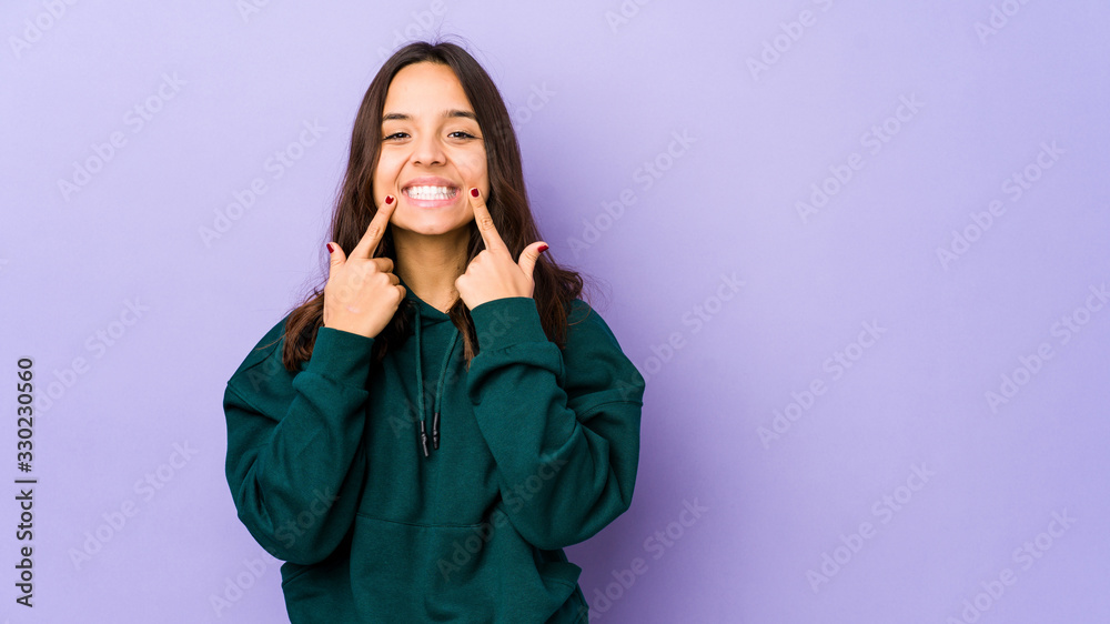Young mixed race hispanic woman isolated doubting between two options. Young mixed race hispanic woman isolated doubting between two options.