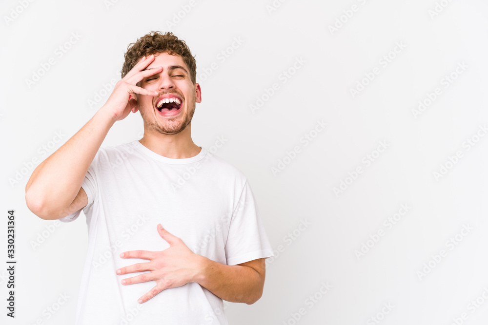 Young blond curly hair caucasian man isolated laughing happy, carefree, natural emotion. Young blond curly hair caucasian man isolated laughing happy, carefree, natural emotion.