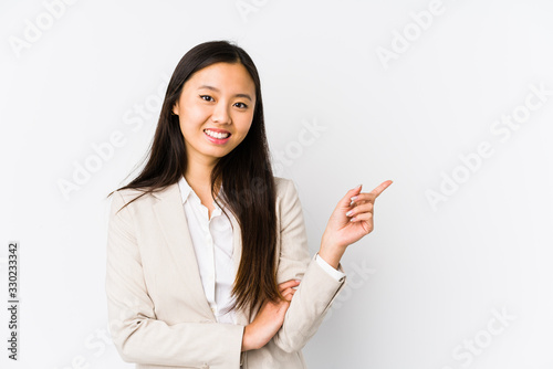 Young business chinese woman isolated smiling cheerfully pointing with forefinger away.