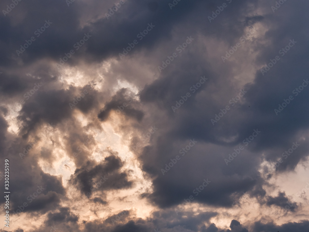 Beautiful sky with clouds at sunset. Soft light from the setting sun. Summer day