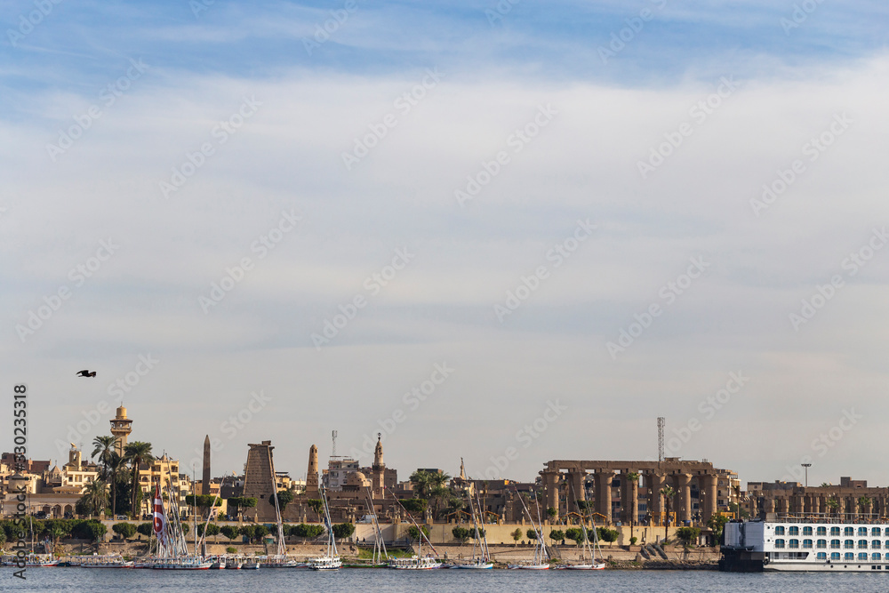 Naklejka premium Luxor, Egypt, Karnak Temple, complex of Amun-Re. View of the ancient city of Thebes from the Nile. Panoramic city, view from the river.