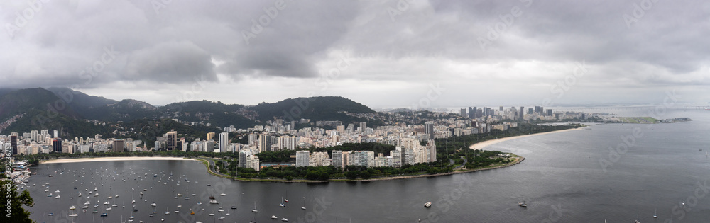 View of Bay displaying boats, apartments, hotels, offices and resorts in Rio de Janeiro on a cloudy day.