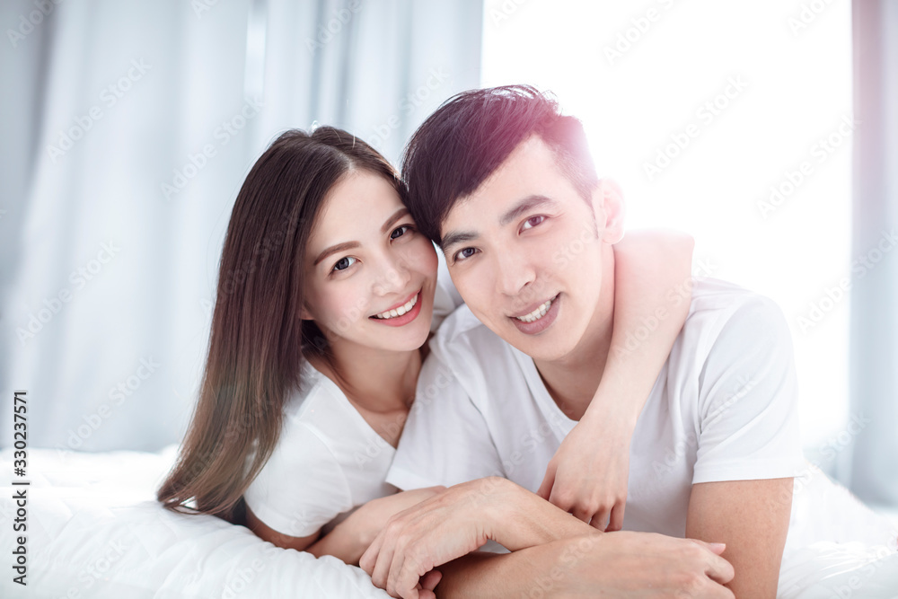 Loving couple on the bed in the bedroom Loving couple on the bed in the bedroom