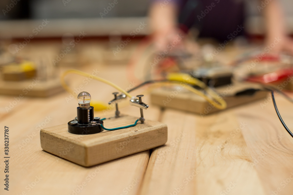 Hands on STEM education activity. Science lesson with hand made electric circuits.