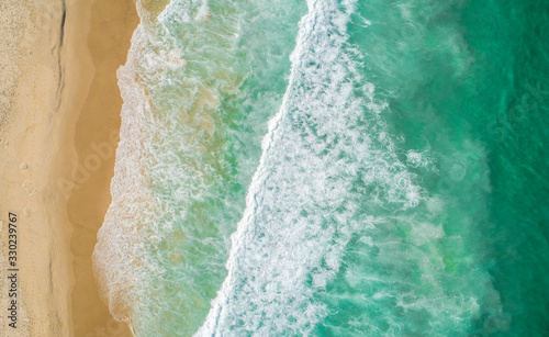 Aerial view of beach; waves rolling toward the shore