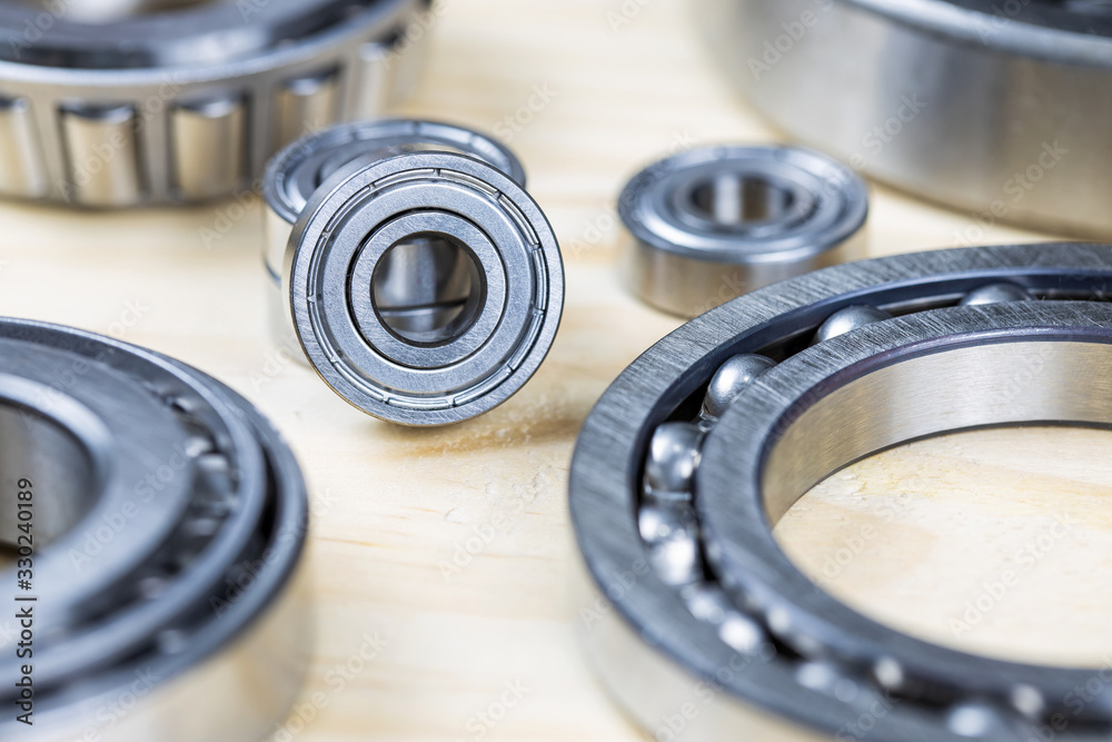 Closeup, Steel ball bearings on wooden plate.. Closeup, Steel ball bearings on wooden plate..