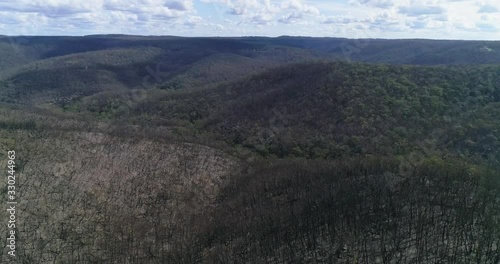 Flying high over burnt bush land near Bundanoon, NSW, Australia. Showing how fire effects hillsides but valleys are less effected photo