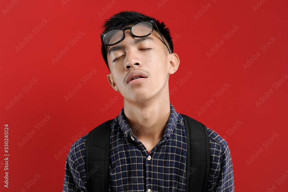 Lazy Young Asian Student feeling tired wearing eyeglasses Lazy Young Asian Student feeling tired wearing eyeglasses