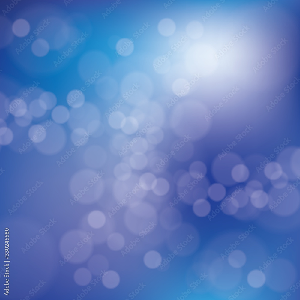 Blurred bright abstract bokeh on blue background.