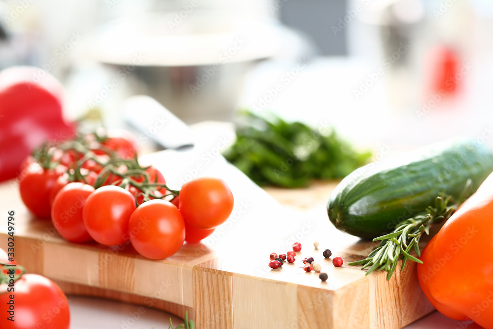 Healthy Organic Vegetables Cutting Board Photo. Small Cherry Tomatoes and Green Cucumber on Wooden Worktop. Aromatic Rosemary and Hot Pepper Spice. Organic Dieting Ingredient Horizontal Photography Healthy Organic Vegetables Cutting Board Photo. Small Cherry Tomatoes and Green Cucumber on Wooden Worktop. Aromatic Rosemary and Hot Pepper Spice. Organic Dieting Ingredient Horizontal Photography
