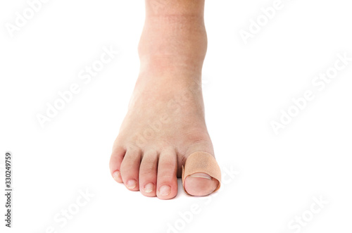 medical plaster on the toe. White background with copy space. Close-up.