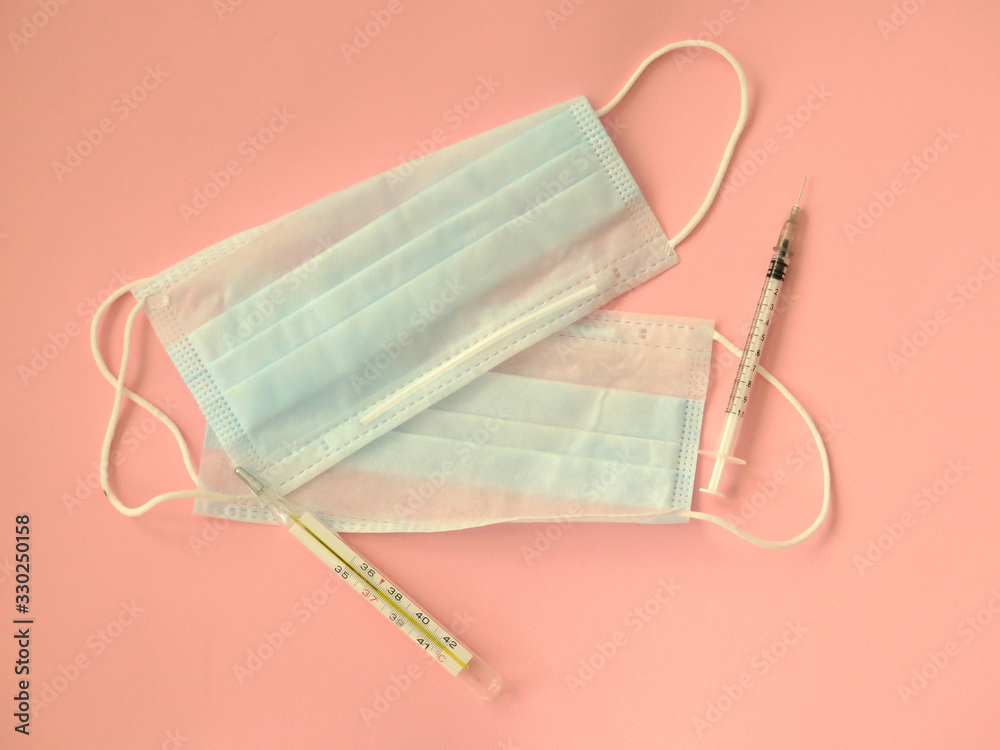 COVID-19. Facial masks on the pile. Pink background. Shortage of facial masks at drug store. Quarantine background. Medical masks for protection. Dangerous virus. COVID-19. Facial masks on the pile. Pink background. Shortage of facial masks at drug store. Quarantine background. Medical masks for protection. Dangerous virus.
