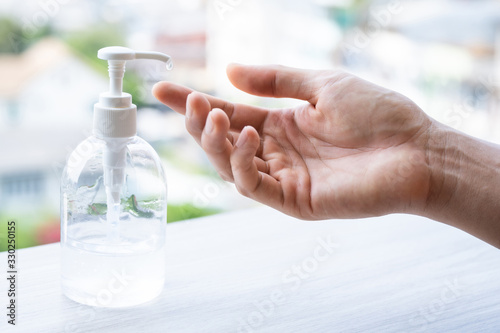 Man hands using sanitizer gel pump dispenser for clean protection coronavirus and bacteria, health care concept, 7 step hands wash