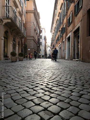 A narrow cobblestone-paved alleyway in Italy