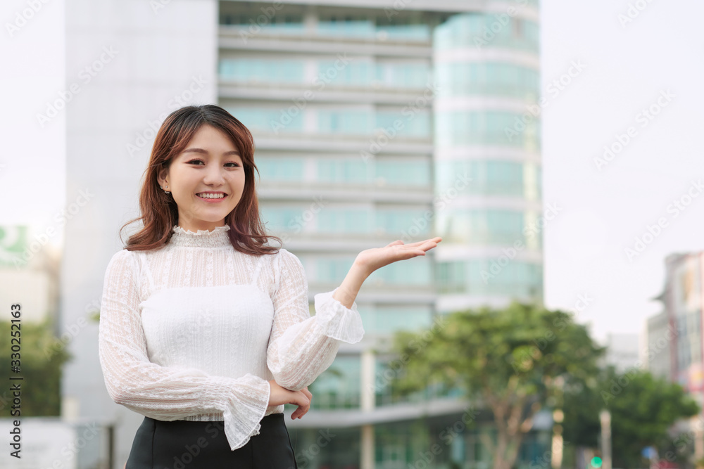 young asian woman hands up to showing something. Hands present product concept