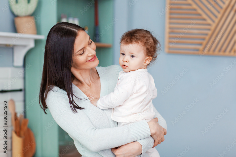 Portrait of a beautiful happy mom and little baby looking at each other Portrait of a beautiful happy mom and little baby looking at each other