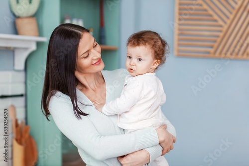 Portrait of a beautiful happy mom and little baby looking at each other