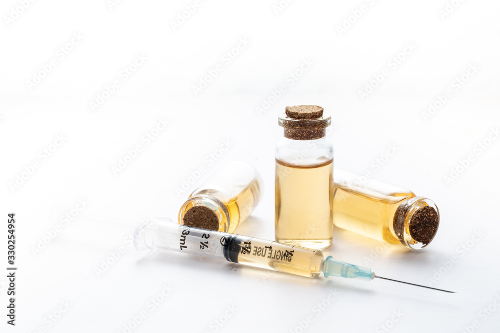 medical syringe with yellow liquid virus on white background