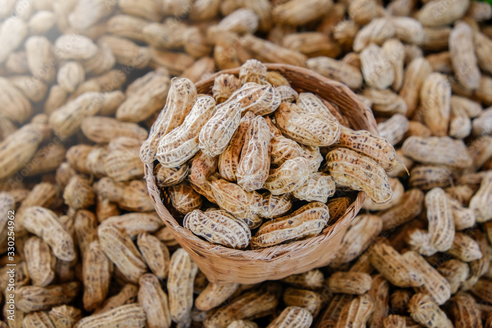 Plenty of dired peanuts in a basket. Plenty of dired peanuts in a basket.