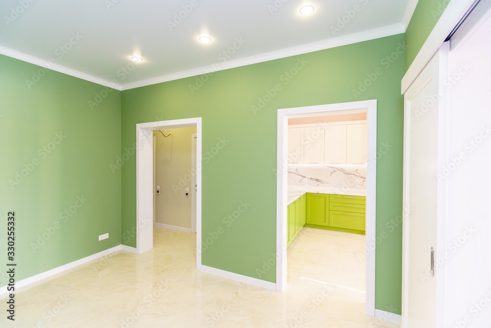 A room in a new building with a fresh renovation. The walls are green and pink, the floors A room in a new building with a fresh renovation. The walls are green and pink, the floors