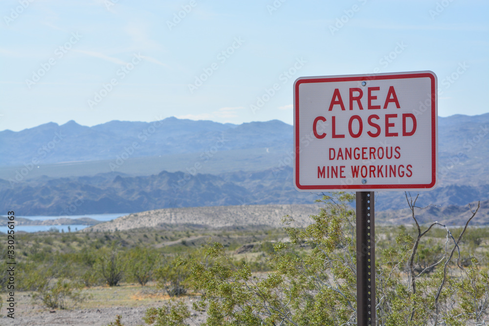 Area Closed Dangerous Mine Workings Sign Abandoned mines in the Lake Mead National Recreation Area. Mohave County, Arizona USA Area Closed Dangerous Mine Workings Sign Abandoned mines in the Lake Mead National Recreation Area. Mohave County, Arizona USA