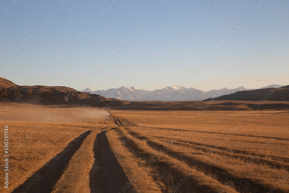 Car on the road in Mongolia. Sing and mountains.